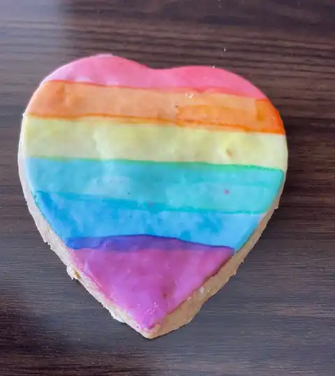 Rainbow-frosted, heart-shaped cookie