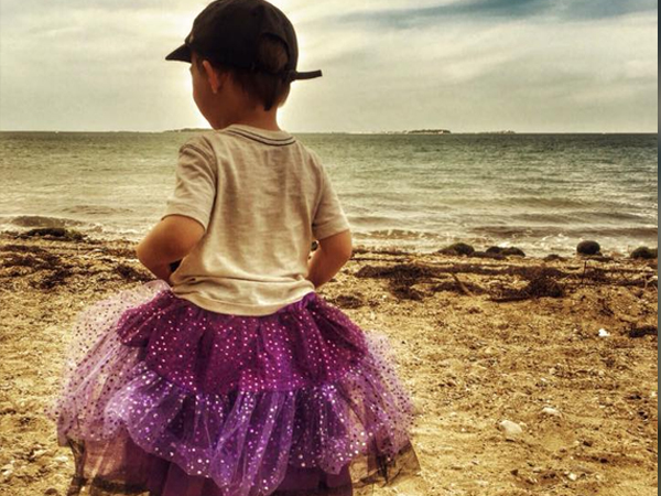 A child on the beach, wearing a fluffy tutu
